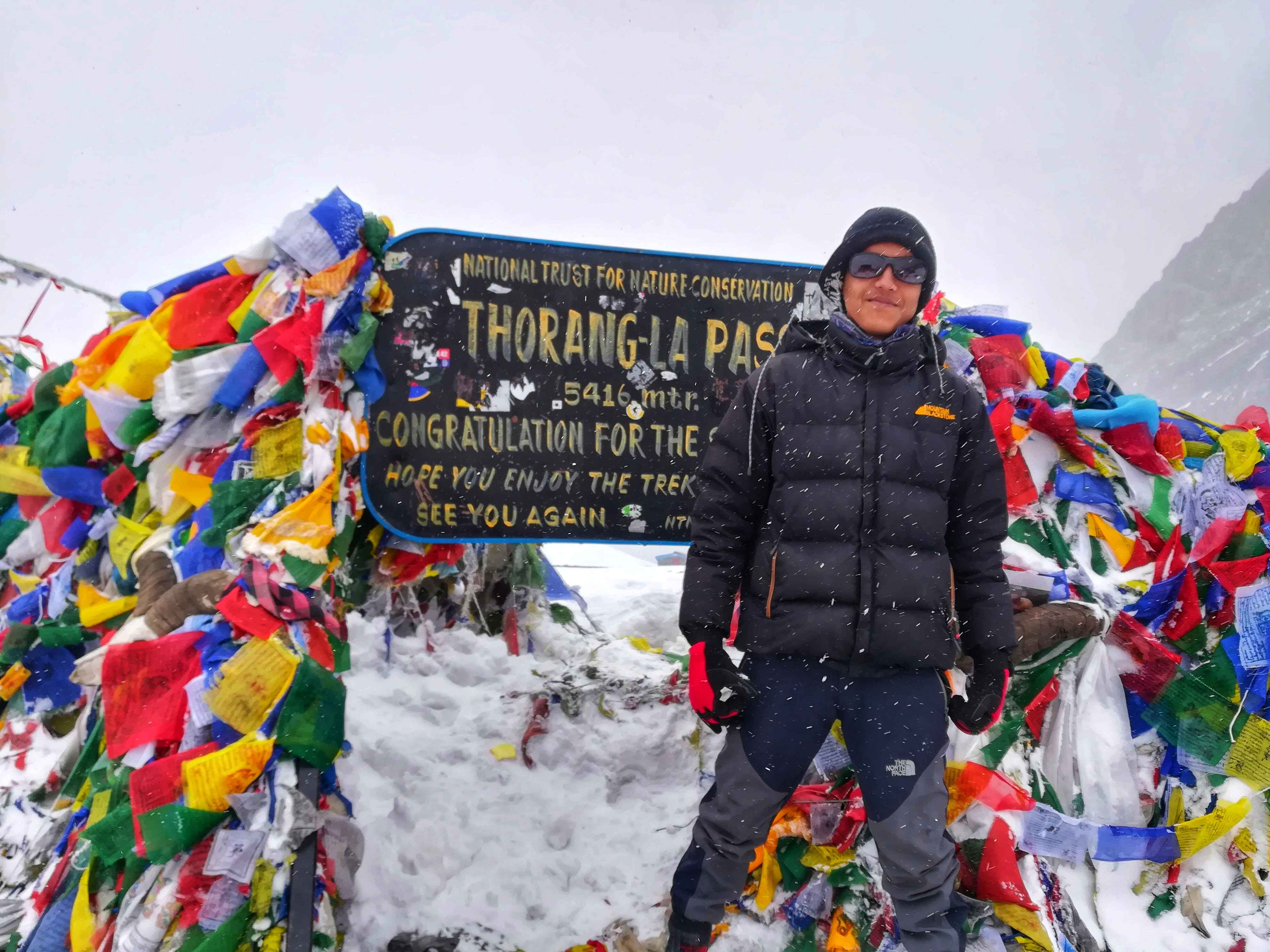 Thorong La Pass 5416, Annapurna Circuit Trek Nepal – snow-capped Himalayas view, solo traveler crossing Throng La Pass, Thorong La Pass Annapurna trekking route Nepal